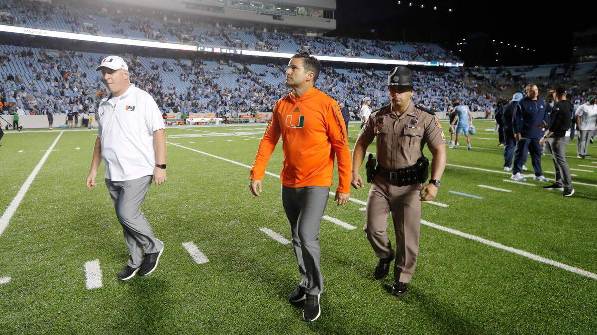 Miami head coach Manny Diaz walks off the field after North Carolina’s 45-42 victory over Miami at Kenan Stadium in Chapel Hill, N.C., Saturday, October 16, 2021.