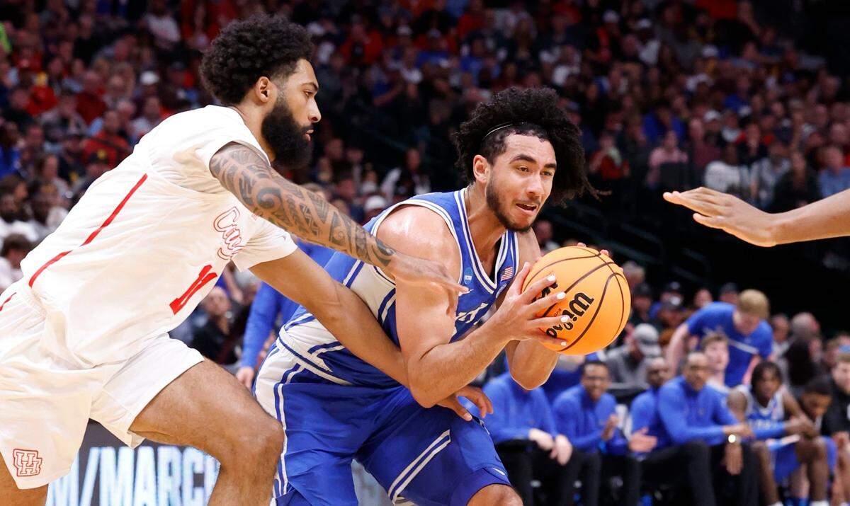Duke’s Jared McCain (0) drives by Houston’s Damian Dunn (11) during the first half of Duke’s game against Houston in their NCAA Tournament Sweet 16 game at the American Airlines Center in Dallas, Texas, Friday, March 29, 2024.