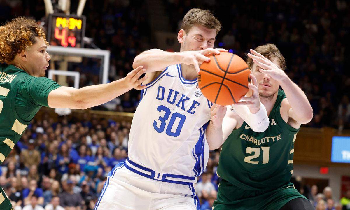 Duke’s Kyle Filipowski (30) drives by Charlotte’s Lu’Cye Patterson (25) and Dean Reiber (21) during the first half of Duke’s game against Charlotte at Cameron Indoor Stadium in Durham, N.C., Saturday, Dec. 9, 2023.