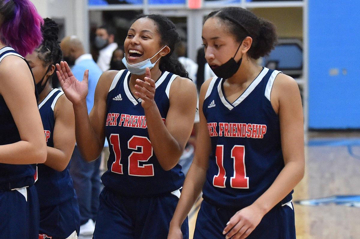 Apex Friendship’s Indya Nivar (12) celebrates with Victoria Sagne (11) after their overtime victory over Panther Creek. The Panther Creek Catamounts and the Apex Friendship Patriots met in a conference basketball game in Cary, NC on January 28, 2022.