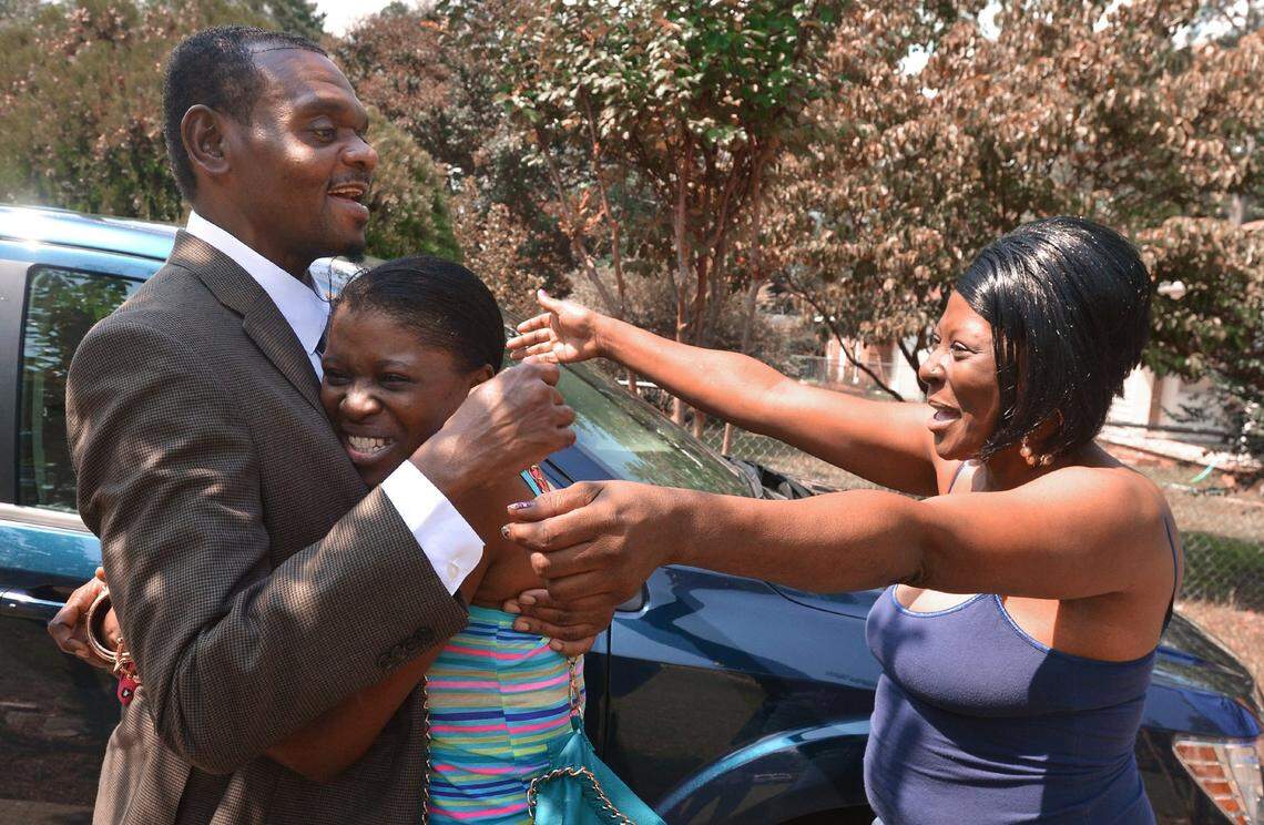 Tracey O’Neal hugs her cousin Henry McCollum as her sister Michelle Wallace rushes in as McCollum arrives at his sister’s home in Fayetteville, N.C. Wednesday, Sept. 3, 2014. McCollum and his brother Leon Brown were released after 30 years in prison when DNA evidence cleared them of the rape and murder of an 11-year old Red Springs girl in 1983.
