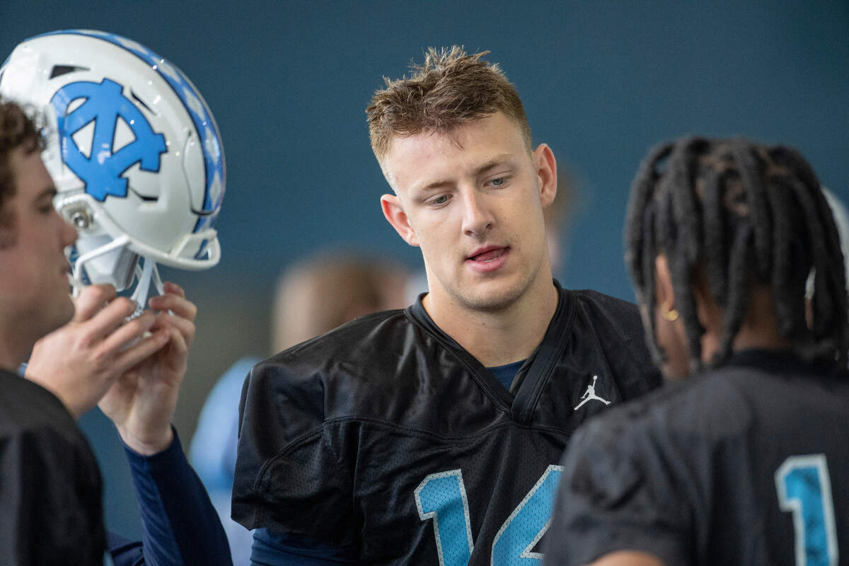 North Carolina graduate transfer quarterback Max Johnson (14) talks with quarterback Conner Harrell (15) during the Tar Heels’ opening day of spring football practice on Tuesday, March 19, 2024 in Chapel Hill, N.C.