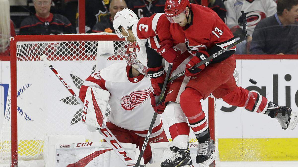 Detroit Red Wings’ Nick Jensen (3) and goalie Jonathan Bernier defend the net in front of Carolina Hurricanes’ Warren Foegele (13) during the first period of an NHL hockey game in Raleigh, N.C., Thursday, Dec. 20, 2018. (AP Photo/Gerry Broome)