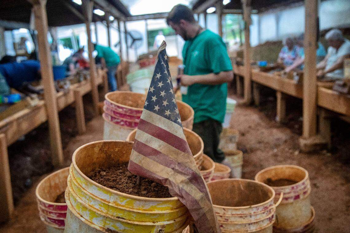 Visitors sift through buckets of clay at the Emerald Hollow Mine in Hiddenite. The mine is billed as “the only Emerald Mine in the world open to the public for prospecting.”