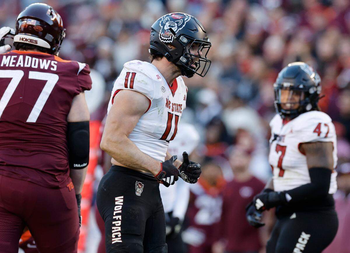 N.C. State linebacker Payton Wilson (11) celebrates after making a stop during the first half of N.C. State’s game against Virginia Tech at Lane Stadium in Blacksburg, VA, Saturday, Nov. 18, 2023.