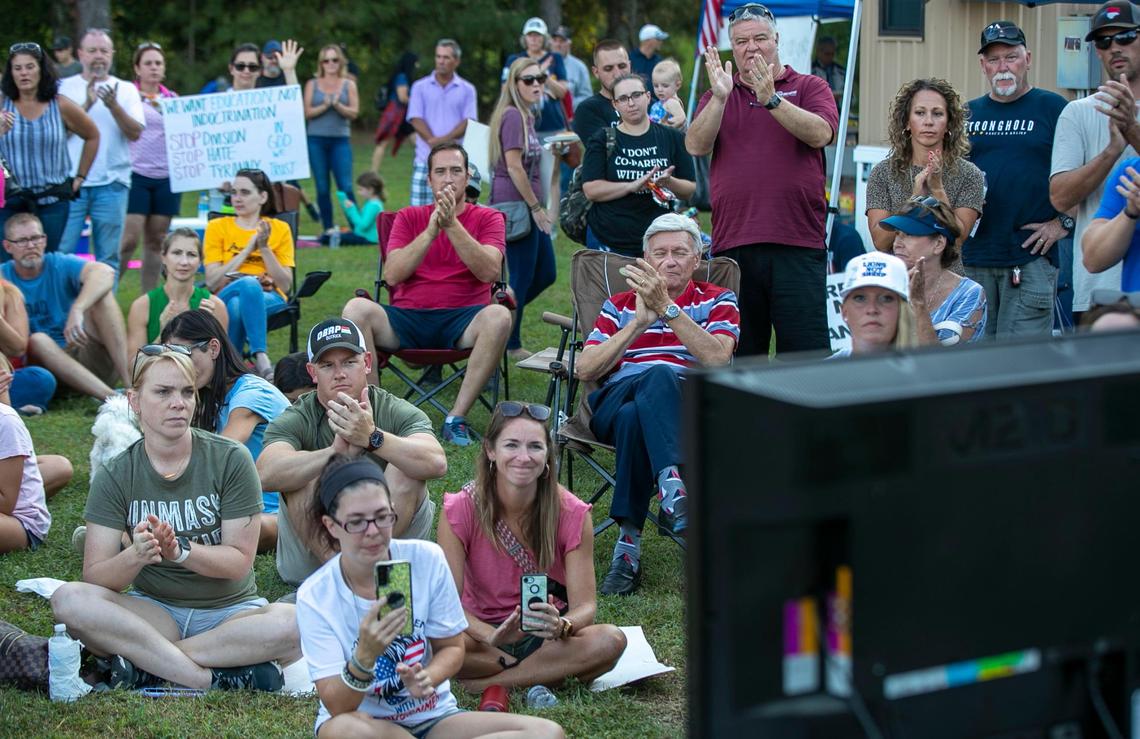 Demonstrators, calling for an end to face mask requirements for students, assemble around a video screen to watch U.S. Rep. Madison Cawthorn as he address the Johnston County Board of Education meeting on Tuesday, September 14, 2021 in Smithfield, N.C.