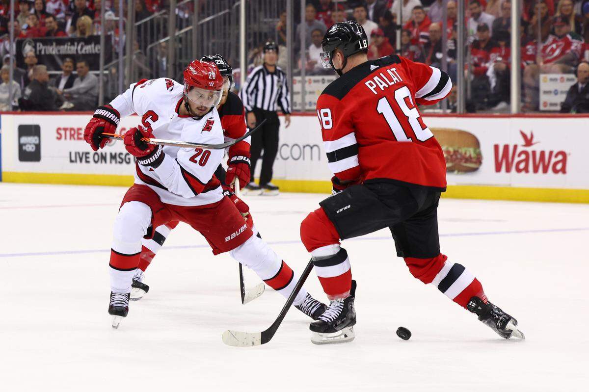 Carolina Hurricanes center Sebastian Aho (20) makes a move past New Jersey Devils left wing Ondrej Palat (18) in game four of the second round of the 2023 Stanley Cup Playoffs at Prudential Center.