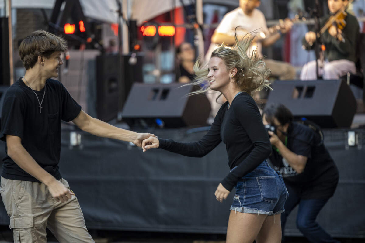 Festival-goers square dance on Martin Street during the Raleigh Wide Open music festival in downtown Raleigh on Friday, Oct. 3, 2025. The event features live bluegrass, folk, Americana and gospel artists.
