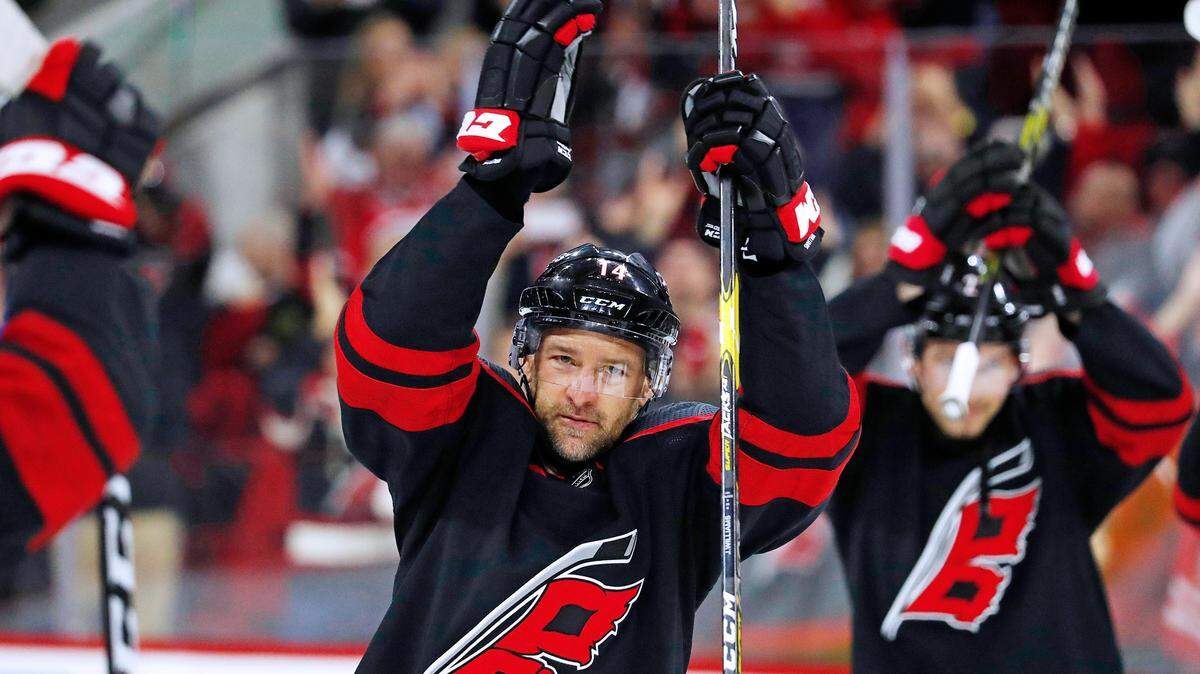 Carolina Hurricanes’ Justin Williams (14) participates in the post game celebration following the Hurricanes 2-1 win over the New York Islanders at an NHL hockey game in Raleigh, N.C., Sunday, Jan. 19, 2020.