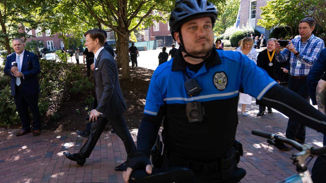 New UNC chancellor Lee Roberts walks behind tight security at ceremonies held on campus, Friday, October 11, 2024 in Chapel Hill.