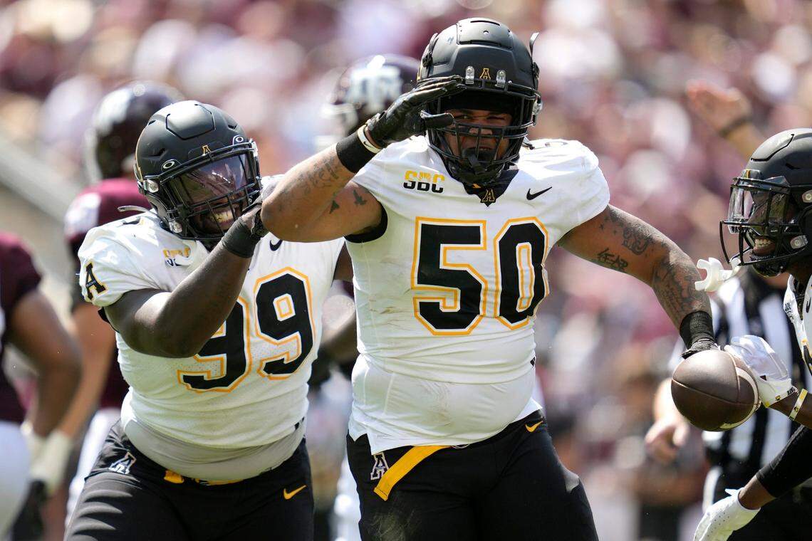 Appalachian State defensive lineman DeAndre Dingle-Prince (50) and teammate Jordon Earle (99) react after recovering a fumble by Texas A&M quarterback Haynes King during the first quarter of an NCAA college football game Saturday, Sept. 10, 2022, in College Station, Texas.