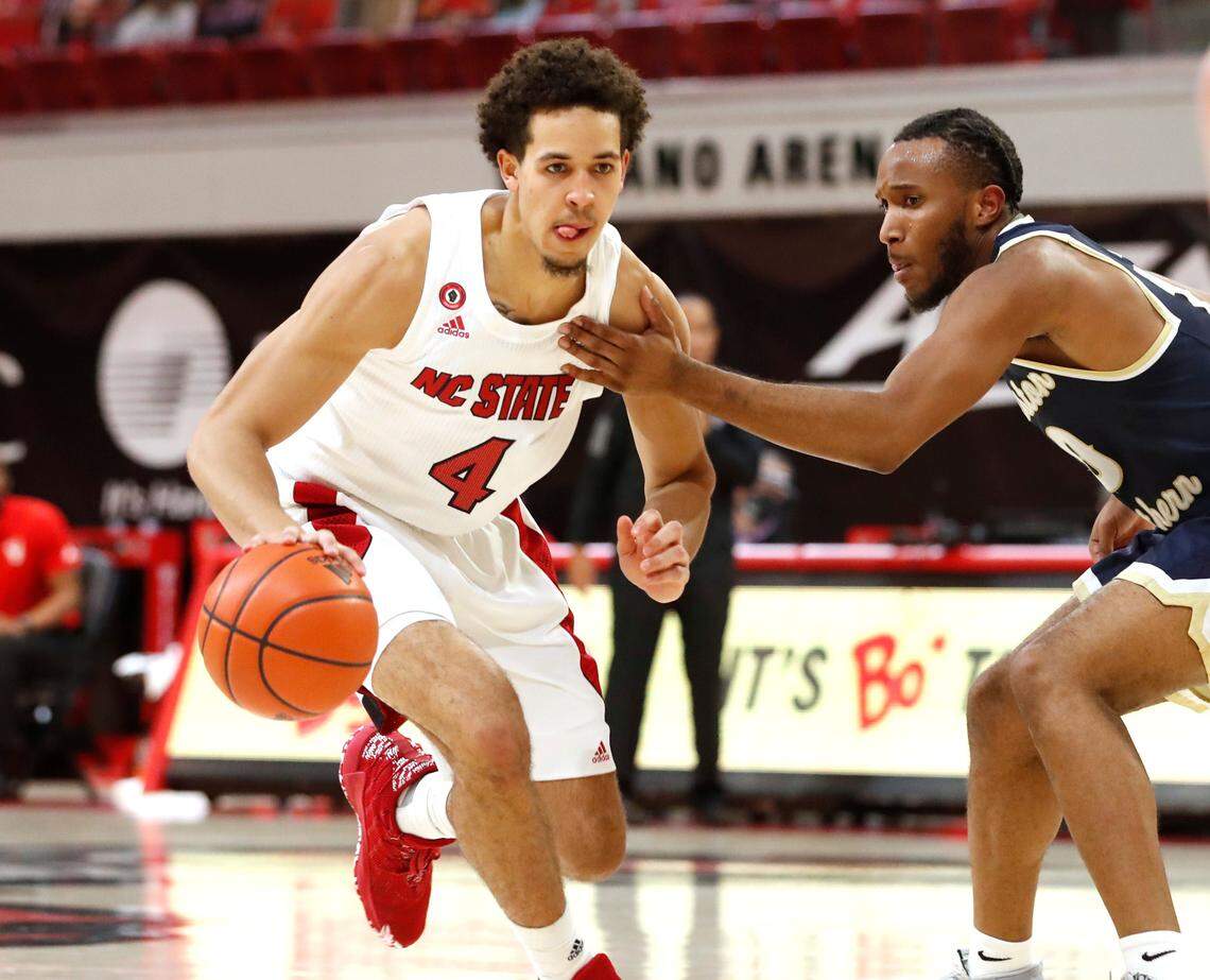 N.C. State’s Jericole Hellems (4) brings the ball past Charleston Southern’s Jamir Moore (10) during N.C. State’s game against Charleston Southern in the Wolfpack Invitational at Reynolds Coliseum in Raleigh, N.C., Wednesday, Nov. 25, 2020.