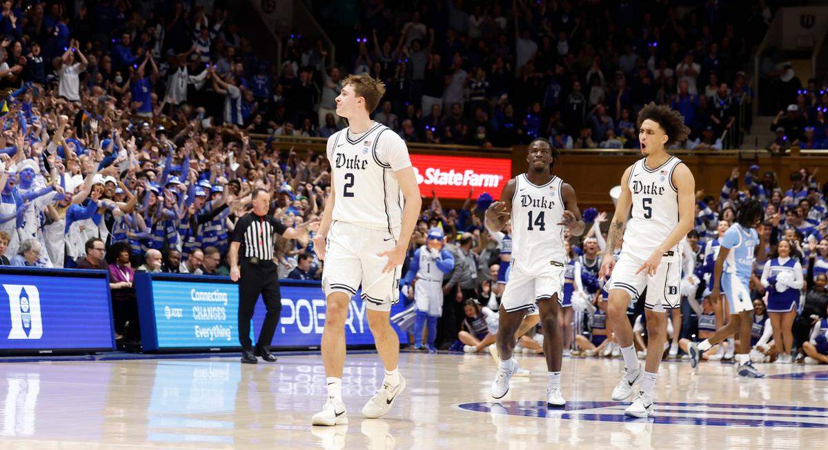 Duke’s Sion James (14) and Tyrese Proctor (5) celebrate with Cooper Flagg (2) during the first half of Duke’s game against UNC at Cameron Indoor Stadium in Durham, N.C., Saturday, Feb. 1, 2025.