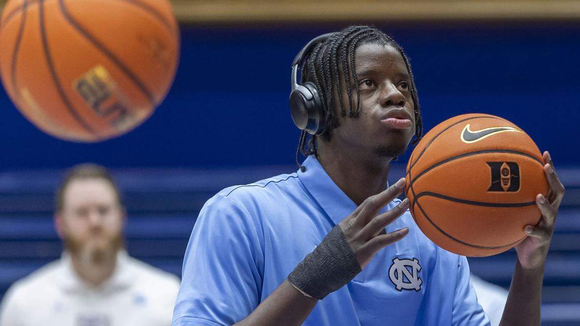 North Carolina forward Caleb Wilson (8), out with a broken thumb, handles the ball, as his teammates warm up for the Tar Heels’ game against Duke on Saturday, March 7, 2026 at Cameron indoor Indoor Stadium in Durham, N.C.