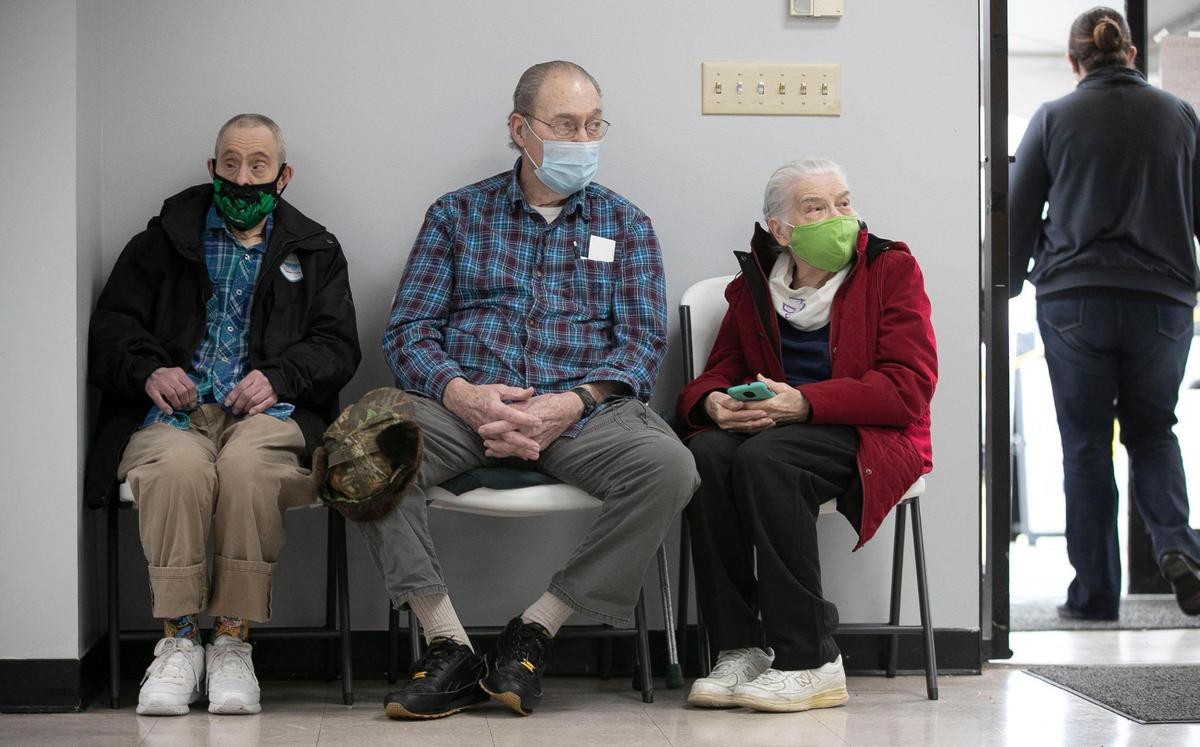 Loren Byrd, his brother G.C. Byrd and G.C.’s wife Peggy Byrd, all of Sampson County, wait 15 minutes before leaving the Dunn Community Center after receiving their second doses of the COVID-19 vaccine during a mass vaccination clinic on Friday, February 12, 2021 in Dunn, N.C. The Byrds live in Sampson County