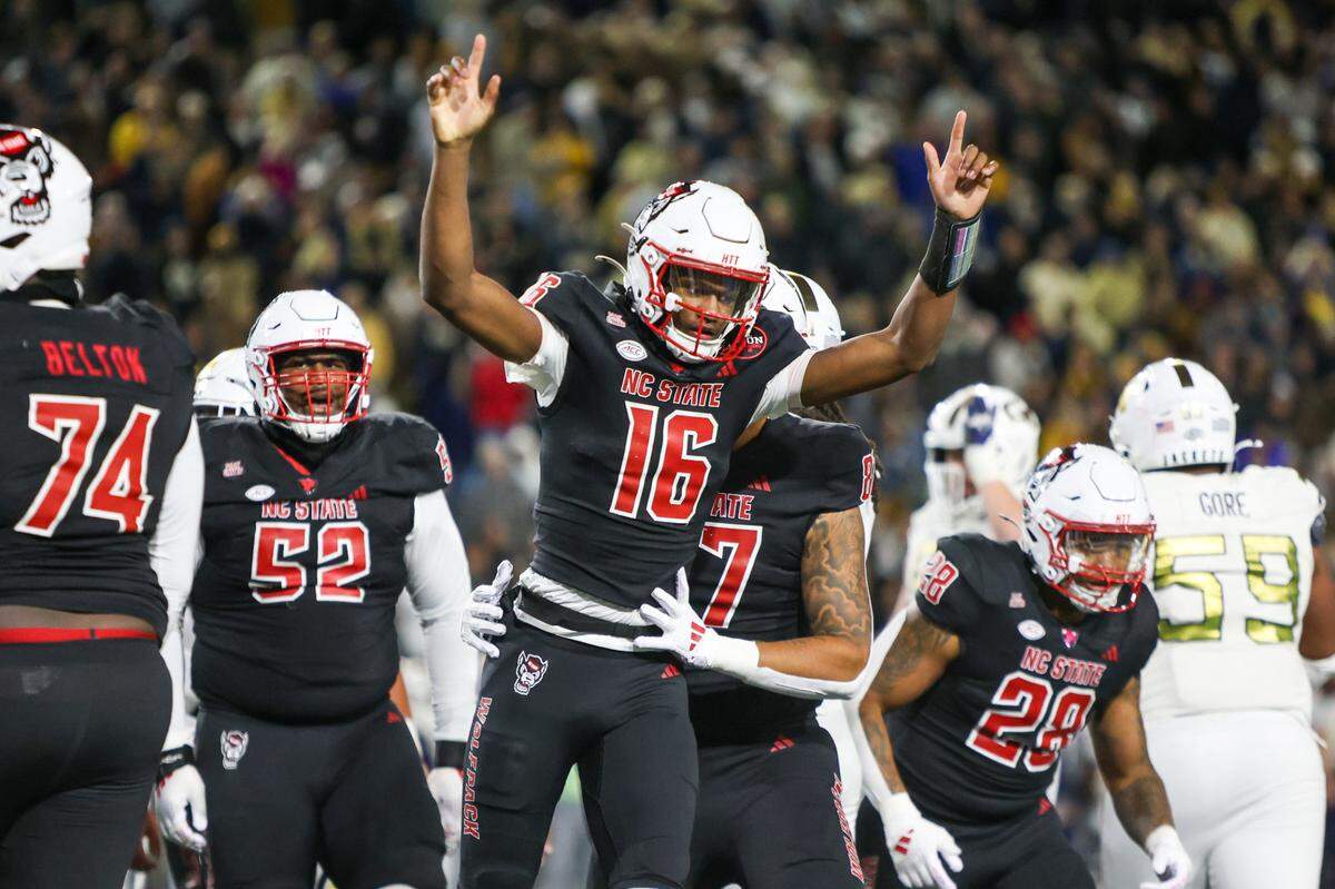 Nov 21, 2024; Atlanta, Georgia, USA; North Carolina State Wolfpack quarterback CJ Bailey (16) celebrates after a touchdown against the Georgia Tech Yellow Jackets in the fourth quarter at Bobby Dodd Stadium at Hyundai Field. Mandatory Credit: Brett Davis-Imagn Images