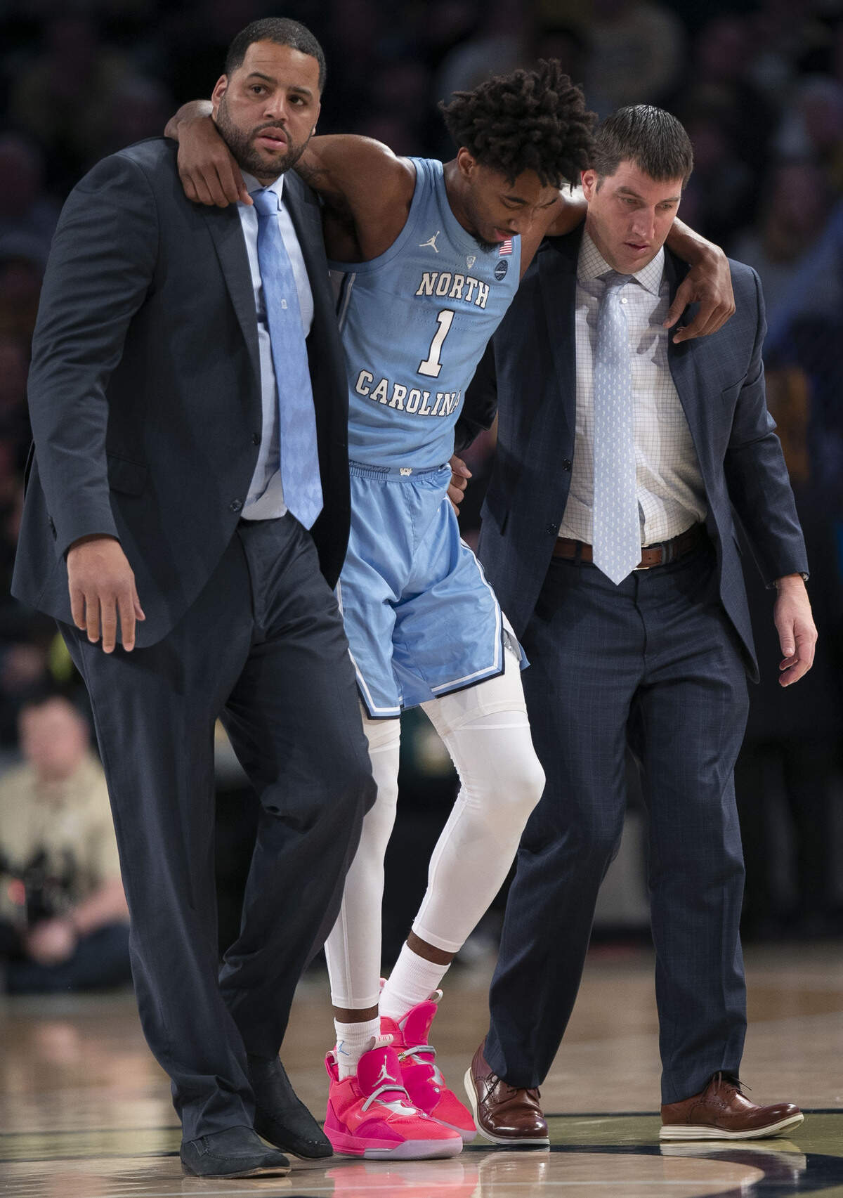 North Carolinas Leaky Black (1) is escorted from the court after spraining his ankle during the second half against Georgia Tech on Tuesday, January 29, 2019 at McCamish Pavilion in Atlanta, Georgia.