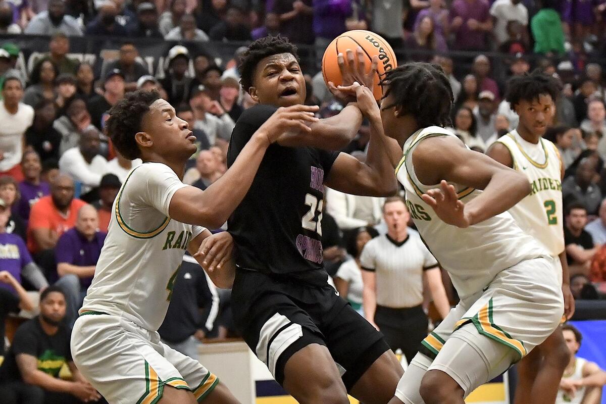 Holly Springs’ Will James (22) drives to the basket against the Richmond defense during the first half. The Richmond Raiders and the Holly Springs Golden Hawks met in the NCHSAA 4A East Regional Finals in Sanford, N.C. on March 4, 2023.