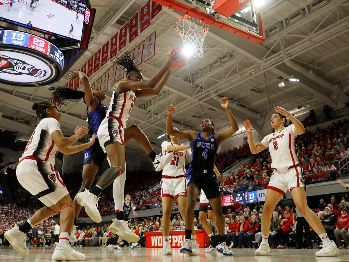 N.C. State’s Saniya Rivers (22) pulls down a rebound during the first half of the Wolfpack’s 72-57 win over Duke on Sunday, Jan. 21, 2024, at Reynolds Coliseum in Raleigh, N.C.