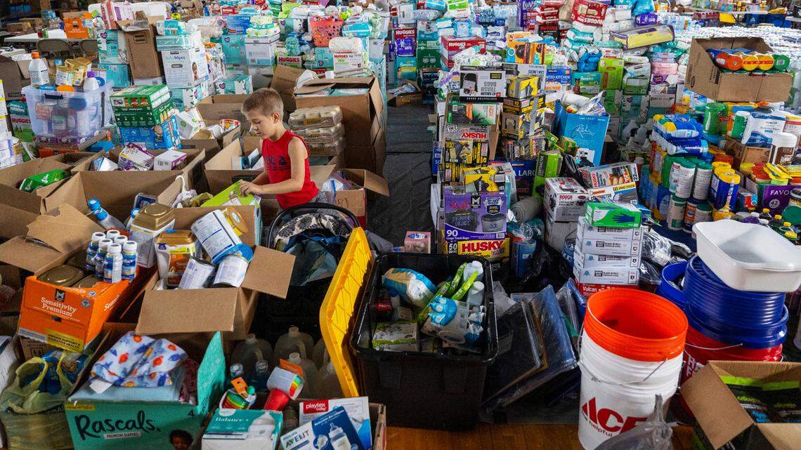 Seven-year-old Zander Reed of Hot Springs, N.C. sorts through a massive amount of donations for Hurricane Helene victims in the gym of Hot Springs Elementary on Friday, October 4, 2024 in Hot Springs, N.C. Donation coordinators said they have plenty of diapers, but are in need of PPE equipment, and muck boots.