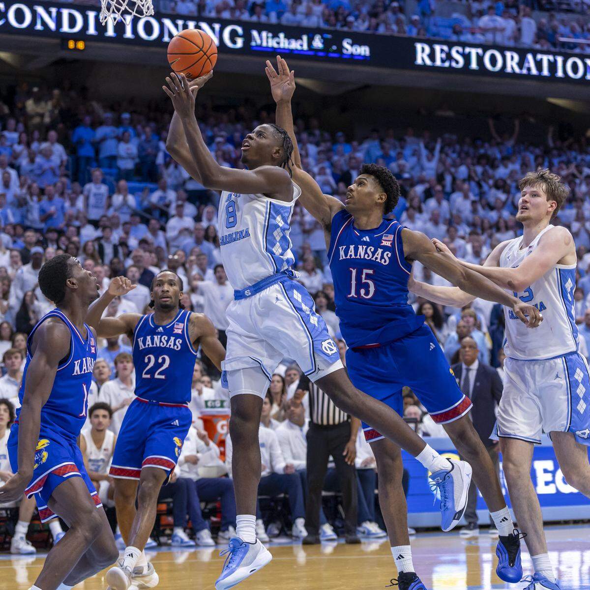 North Carolina forward Caleb Wilson (8) drives to the basket against Kansas forward Bryson Tiller (15) in the second half on Friday, November 7, 2025 at the Smith Center in Chapel Hill, N.C.