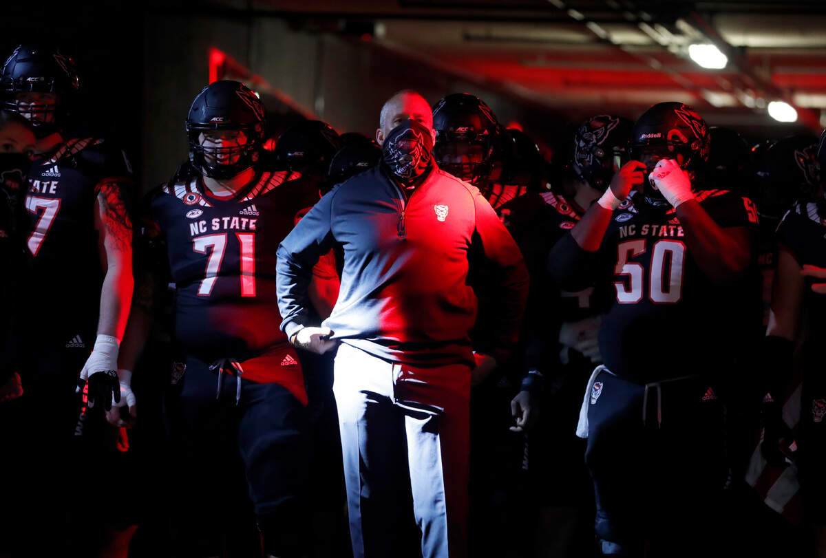 N.C. State head coach Dave Doeren prepares to lead his team onto the field before N.C. State’s game against Miami at Carter-Finley Stadium in Raleigh, N.C., Friday, Nov. 6, 2020.