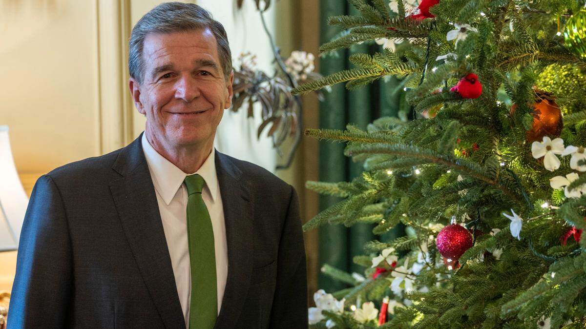 Gov. Roy Cooper with the State Christmas Tree at the Executive Mansion Monday, Dec. 16, 2022.