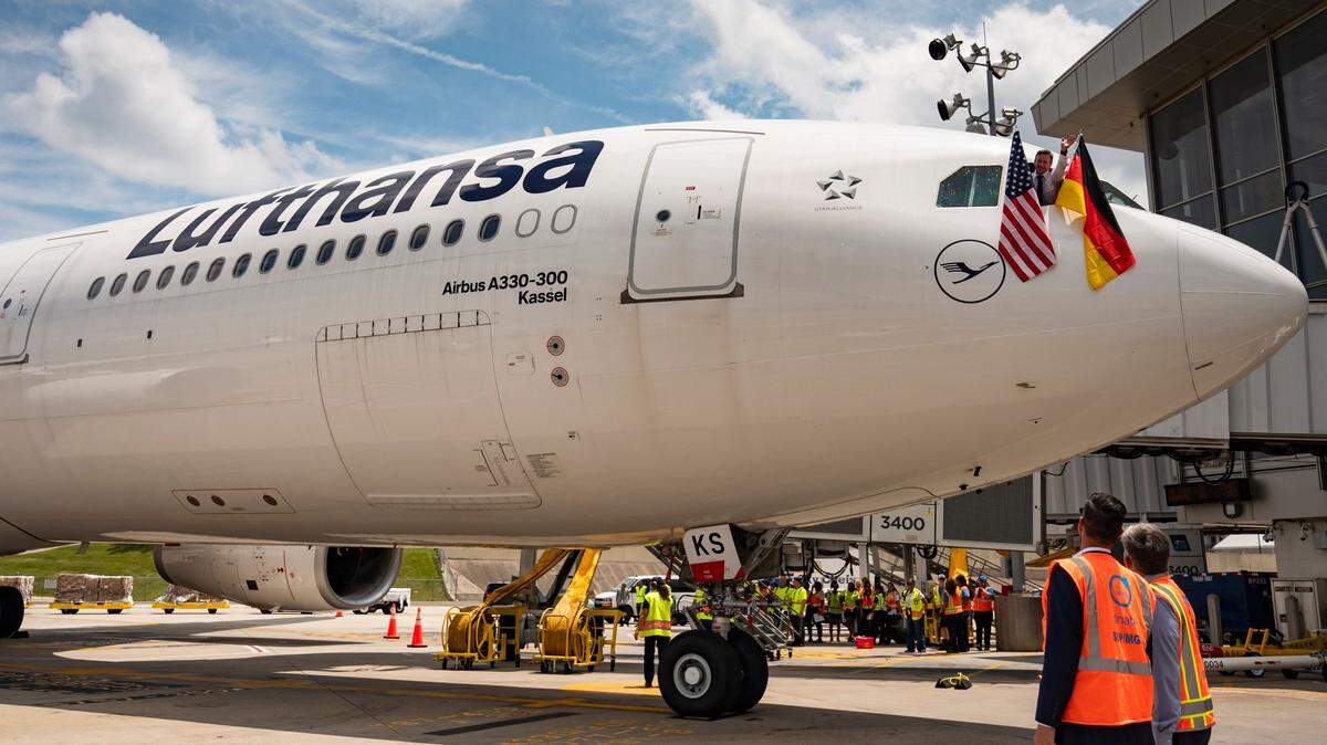 An American and German flag are waved out the window of the first nonstop Lufthansa flight from Frankfurt, Germany, to the Raleigh-Durham International Airport on June 6, 2024.