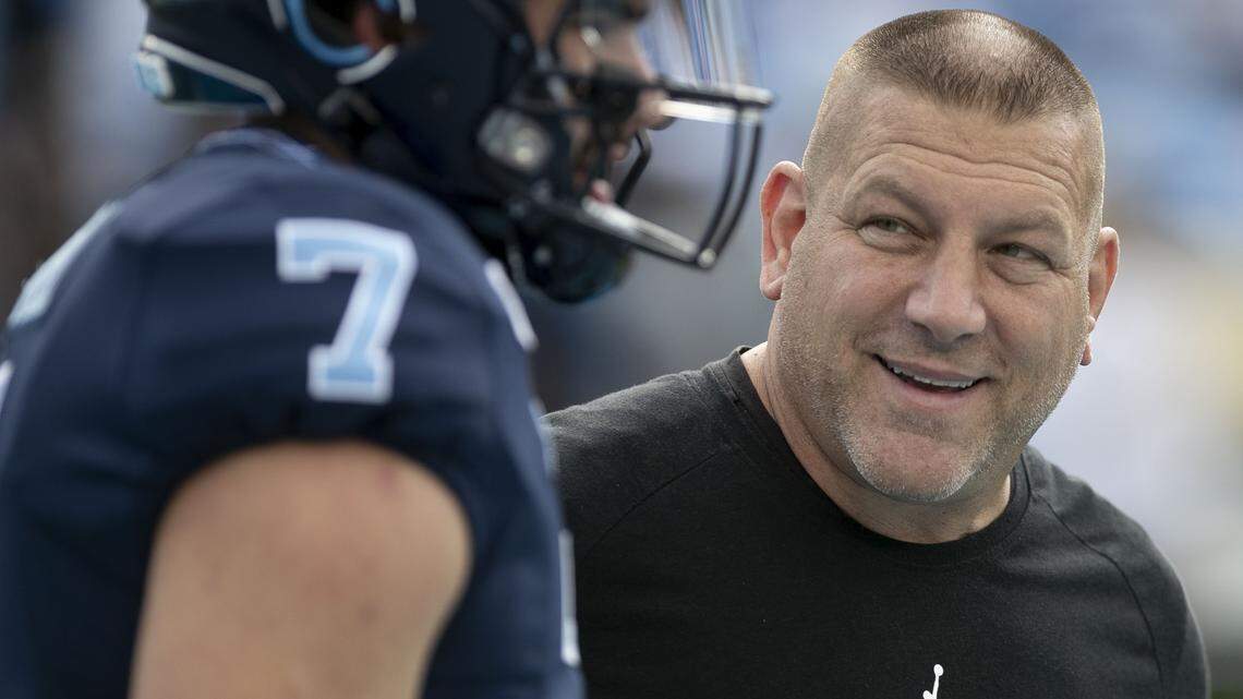 North Carolina offensive coordinator Phil Longo talks with quarterback Sam Howell prior to the Tar Heels’ game against Duke on Saturday, October 26, 2019 at Kenan Stadium in Chapel Hill, N.C.