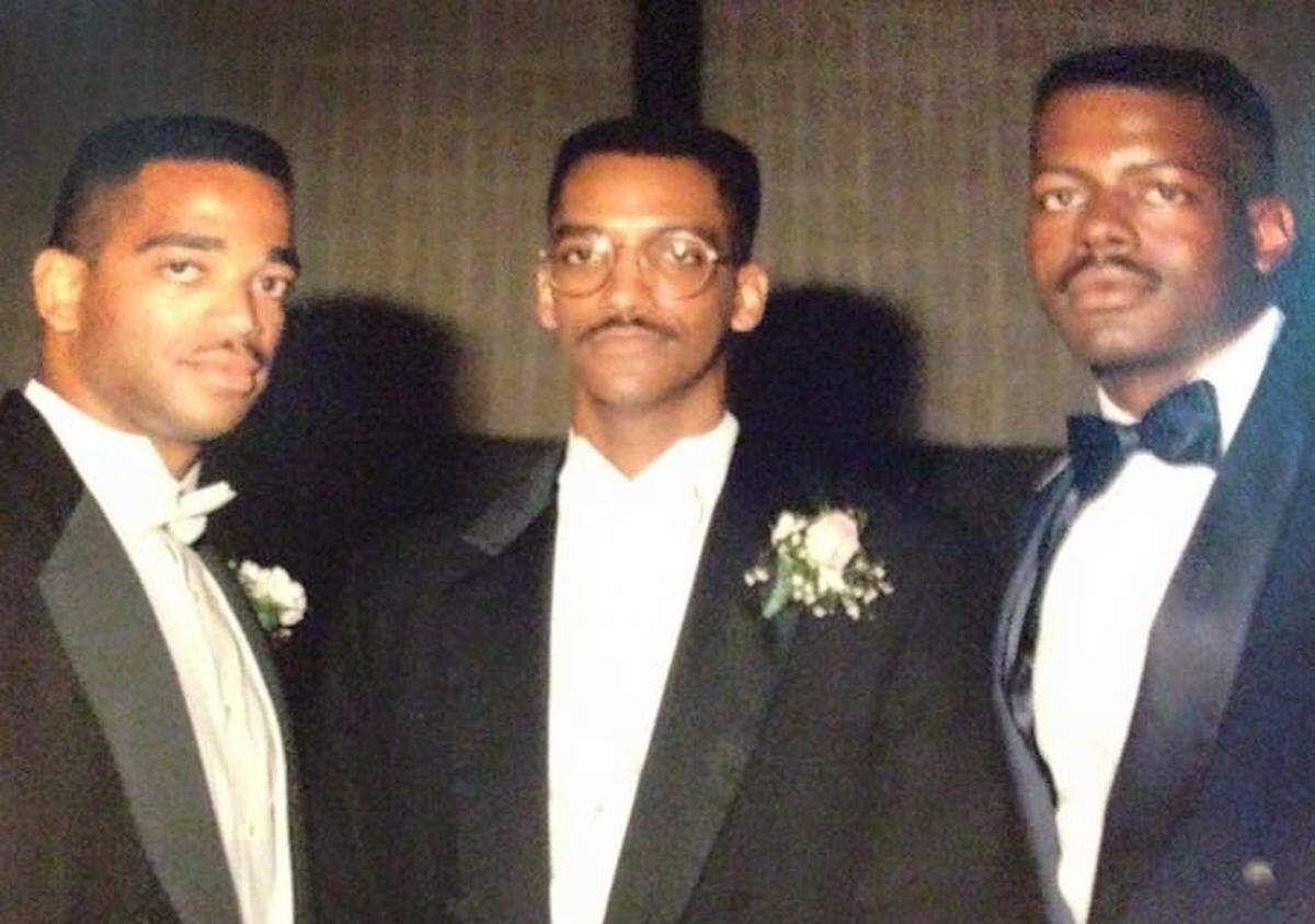 Stuart Scott, left, and Fred Tindal, right, photographed at the 1991 wedding of Fred Evans, center. 