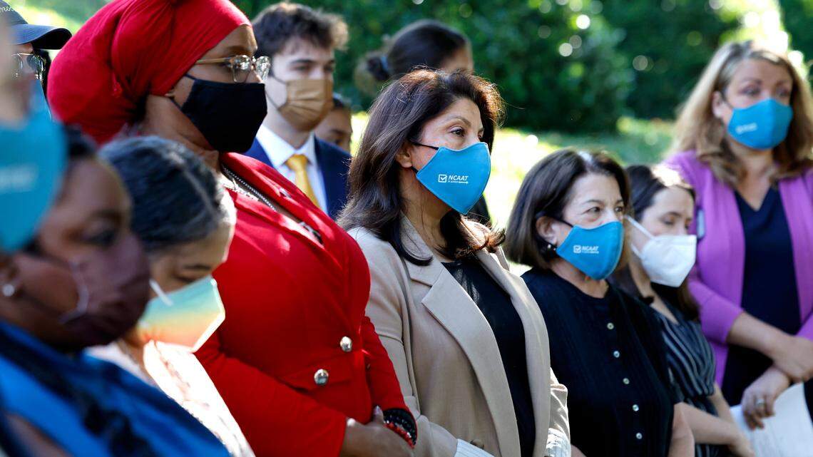 Shruti Parikh, center, head of Education and Political Engagement of North Carolina Asian Americans Together and others listen during a press conference against House Bill 237, the anti-mask and campaign finance bill, outside the Legislative Building in Raleigh, N.C., Tuesday, June 11, 2024.