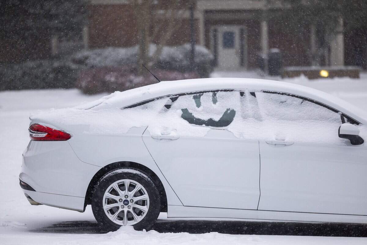 A smiley face is drawn in snow on the window of a car parked in Chapel Hill on Saturday afternoon, Jan. 31, 2026, as a winter storm brings snow and freezing temperatures to the region.