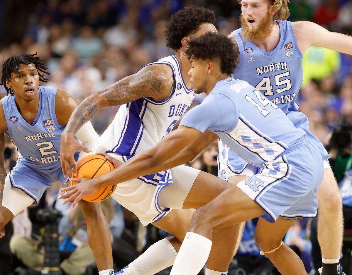 North Carolina’s Puff Johnson (14) steals the ball from Dukes Paolo Banchero (5) during the first half of Dukes game against UNC in the Final Four at Caesars Superdome in New Orleans, La., Saturday, April 2, 2022.