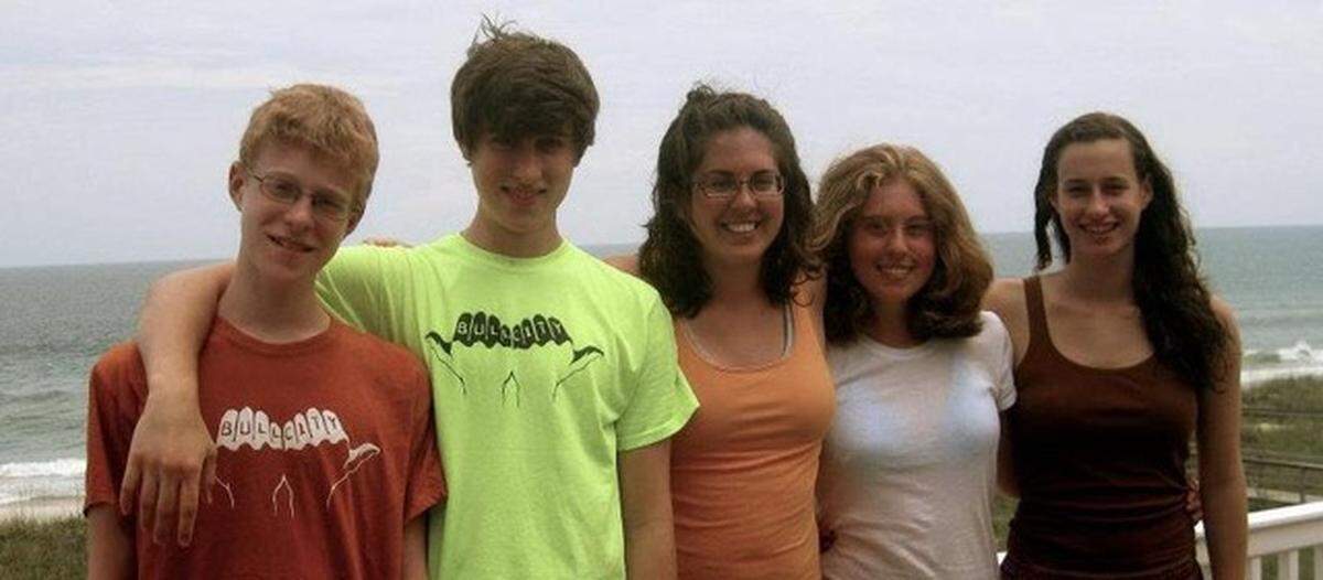 Jacob Streilein, second from left, wears one of the Bull City shirts he designed in 2010 with fellow Riverside High School student Chris Alton. unpictured. Safety Yellow/Green was the most popular color.