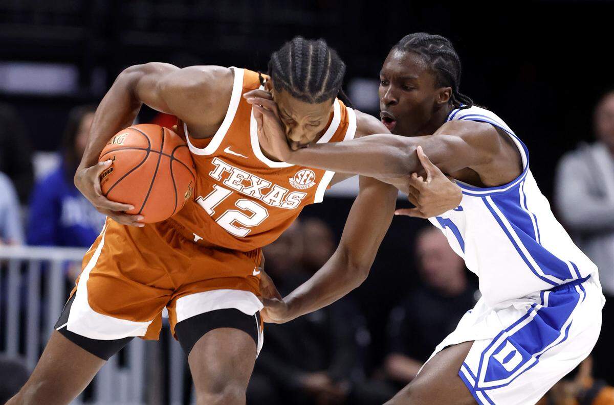 Duke’s Dame Sarr (7) defends Texas’ Tramon Mark (12) during the first half of Duke’s game against Texas in the Dick Vitale Invitational at the Spectrum Center in Charlotte, N.C., Tuesday, Nov. 4, 2025.