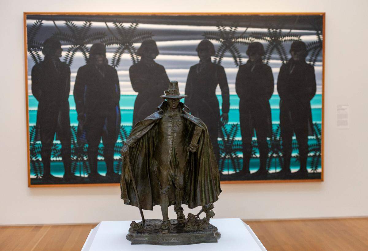 "The Puritan," a sculpture by Augustus Saint-Gaudens is positioned in front of a large painting ‘American Landscape with Revolutionary Heroes’ by Roger Brown in the American Gallery on Sept. 20, 2022, in Raleigh.