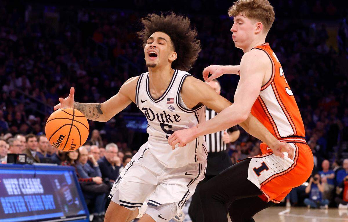 Duke’s Tyrese Proctor (5) is fouled by Illinois’ Kasparas Jakucionis (32) during the first half of Duke’s game against Illinois in the SentinelOne Classic at Madison Square Garden in New York City Saturday, Feb. 22, 2025.