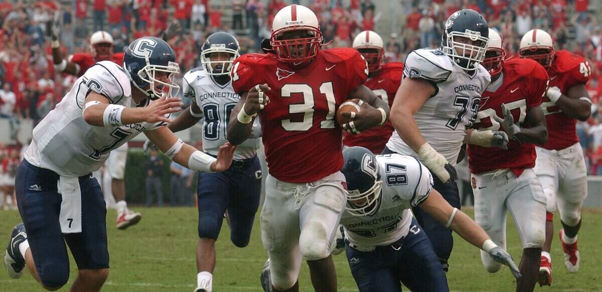 N.C. State’s Freddie Aughtry-Lindsay (31) races towards the end zone after intercepting a pass in the closing seconds to give the Wolfpack a 31-24 victory over UConn in 2003.