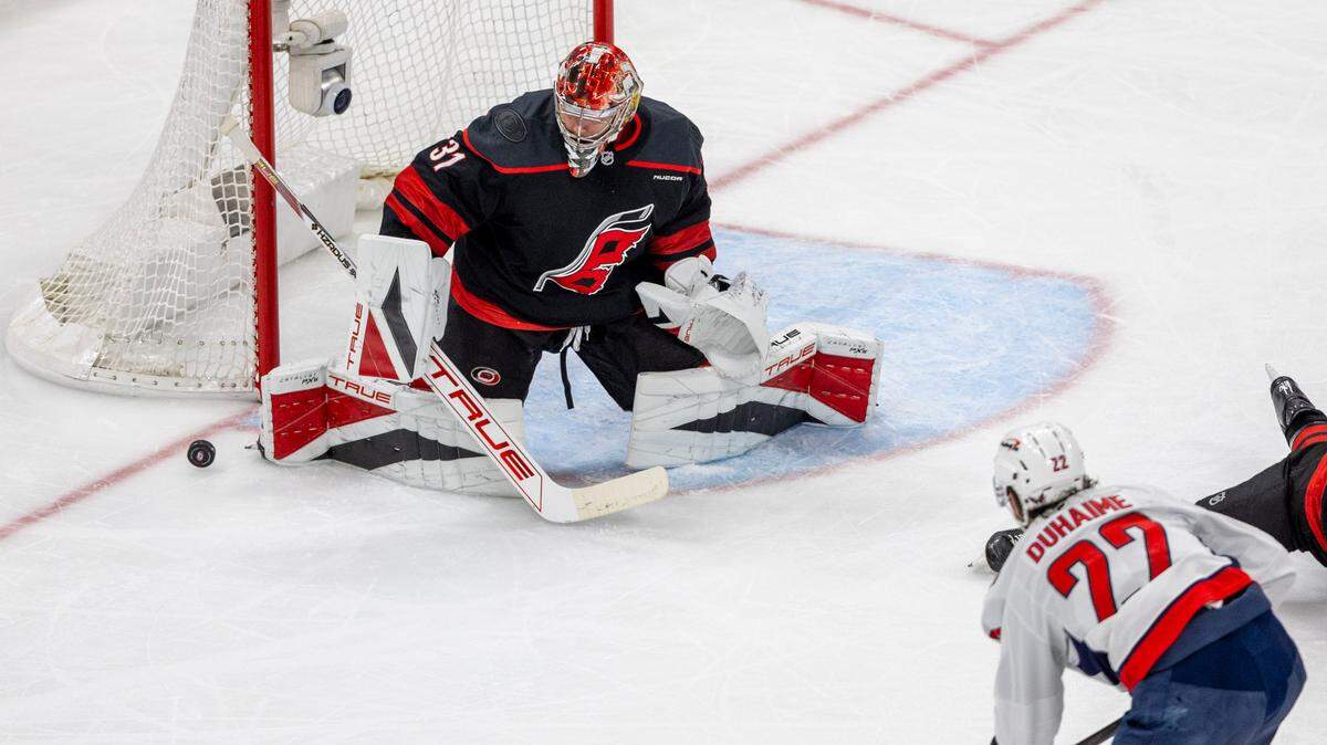 Carolina Hurricanes goalie Frederik Andersen (31) deflects a shot by Washington Capitals right wing Brand Duhaime (22) in the second period during Game 4 of their series on Monday, May 12, 2025 at Lenovo Center in Raleigh, N.C.