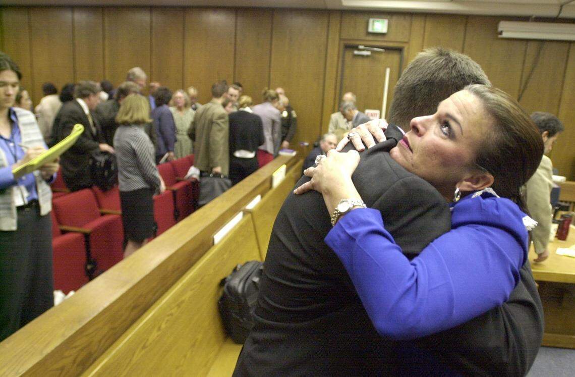 Durham asst. DA Freda Black, after just having hugged Durham DA Jim Hardin also embraced her colleague, asst. DA David Saacks after convicted defendant Michael Peterson was read the jury’s guilty verdict and escorted from the courtroom in handcuffs. The Peterson jury returned a first degree murder verdict and the emotional release was immediate for the prosecution after several months of daily Peterson courtroom activity. Members of the Peterson family and supporters exit the courtroom at left.