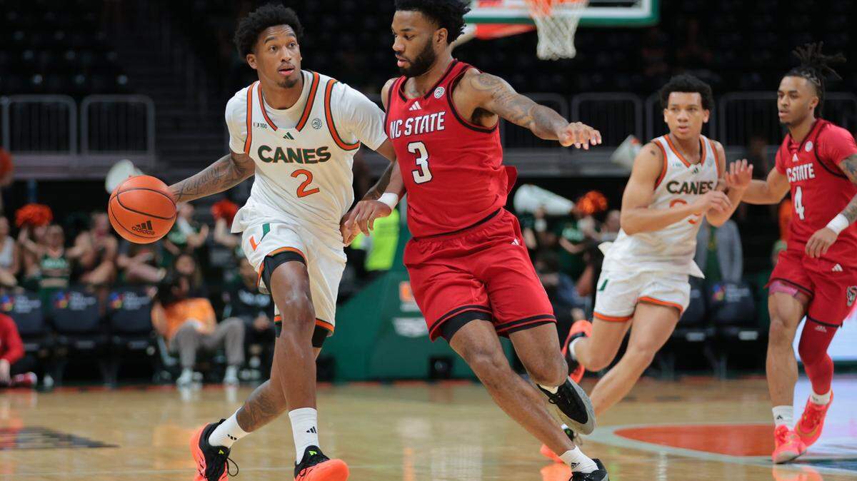Miami Hurricanes forward Brandon Johnson (2) dribbles the basketball as North Carolina State Wolfpack guard Dontrez Styles (3) defends during the first half of their ACC basketball game at the Watsco Center in Coral Gables, Florida on Saturday, March 8, 2025.