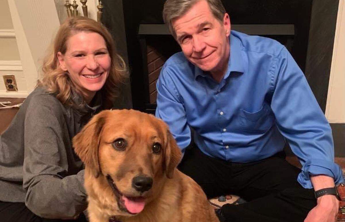 North Carolina First Lady Kristin Cooper, left, and Gov. Roy Cooper, right, welcomed a new first pet to the family, a rescue dog named Violet.