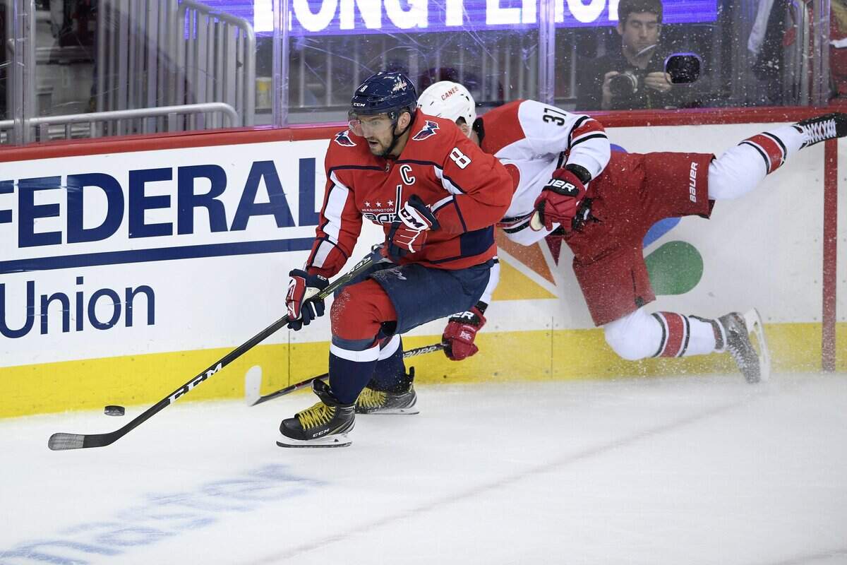 Washington Capitals left wing Alex Ovechkin (8), of Russia, chases the puck past Carolina Hurricanes right wing Andrei Svechnikov (37), of Russia, during the third period of Game 2 of an NHL hockey first-round playoff series, Saturday, April 13, 2019, in Washington. The Capitals won 4-3 in overtime.
