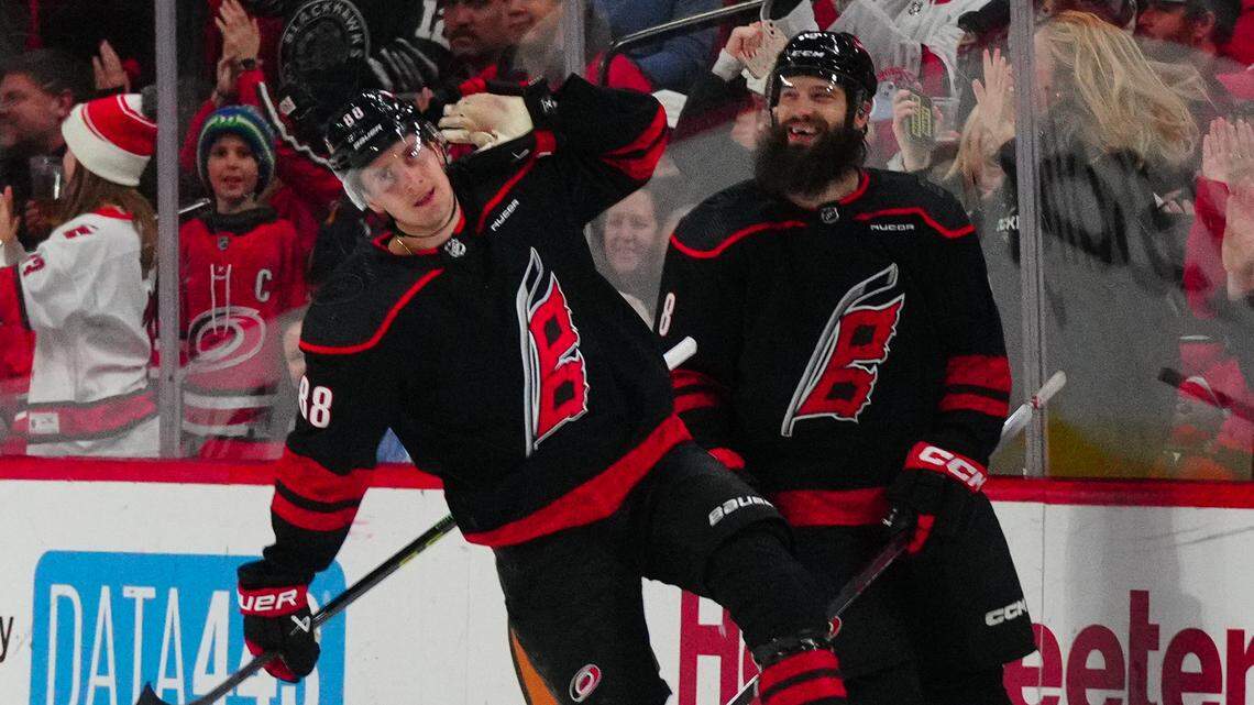 Jan 19, 2024; Raleigh, North Carolina, USA; Carolina Hurricanes center Martin Necas (88) celebrates his goal against the Detroit Red Wings during the second period at PNC Arena. Mandatory Credit: James Guillory-USA TODAY Sports