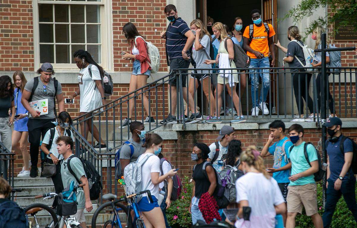 University of North Carolina students file out of Dey Hall during the first day of classes on Wednesday, August 18, 2021 in Chapel Hill, N.C. Thousands of students have returned to campus amid a surge in COVID-19 cases.