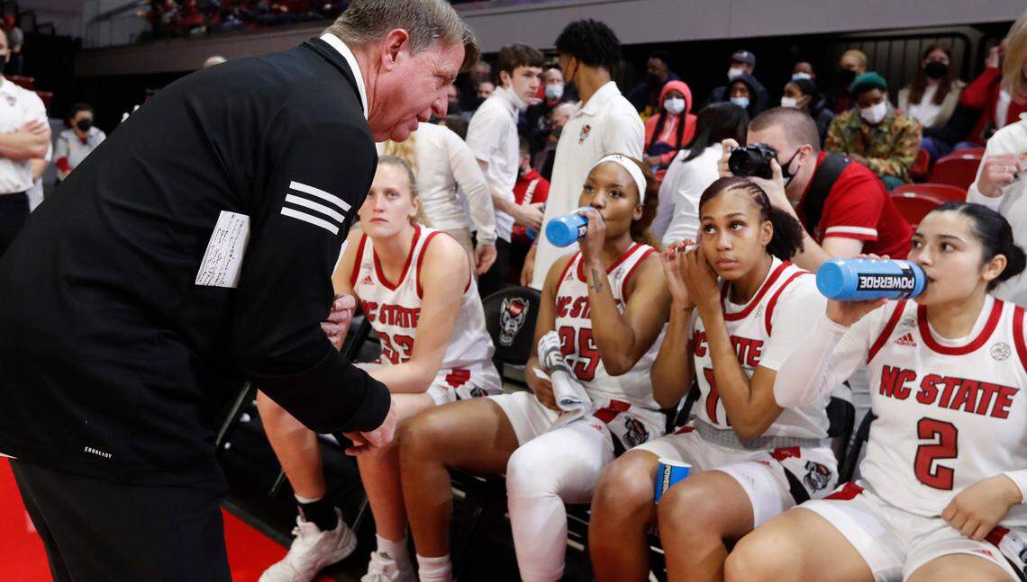 N.C. State head coach Wes Moore talks with his players before team introductions before the Wolfpack’s game against Louisville at Reynolds Coliseum in Raleigh, N.C., Thursday, Jan. 20, 2022.