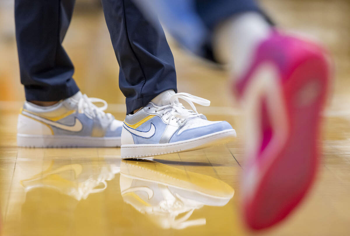 North Carolina assistant coach Marcus Paige works with players during pre-game warm ups, sporting a pair of custom painted shoes on Monday, Feb. 2, 2026 at the Smith Center in Chapel Hill, N.C. The shoes were painted by patients from UNC Children’s Hospital as part of a fundraiser for the fight against pediatric cancer. 