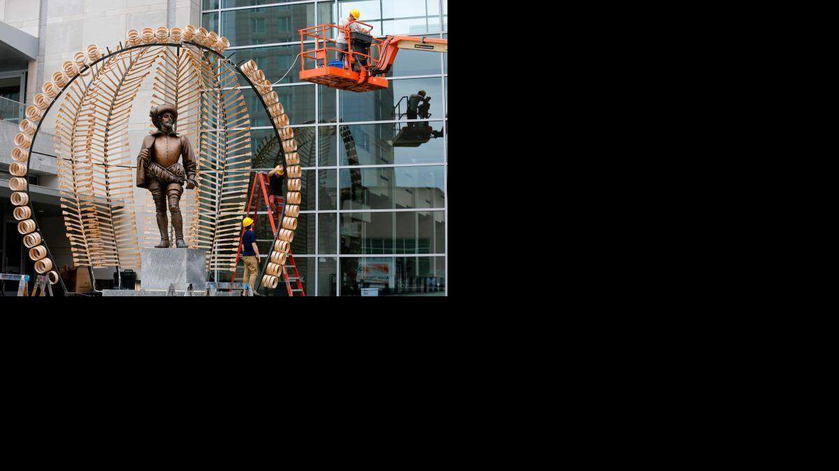 From left: Josh Lenker, David Dahlin, and artist Bland Hoke, install the final steel piece to “Banjostand” on Monday outside of the Raleigh Convention Center. “Banjostand” is a public art installation made from hundreds of castoff banjo parts to create a bandstand. 
