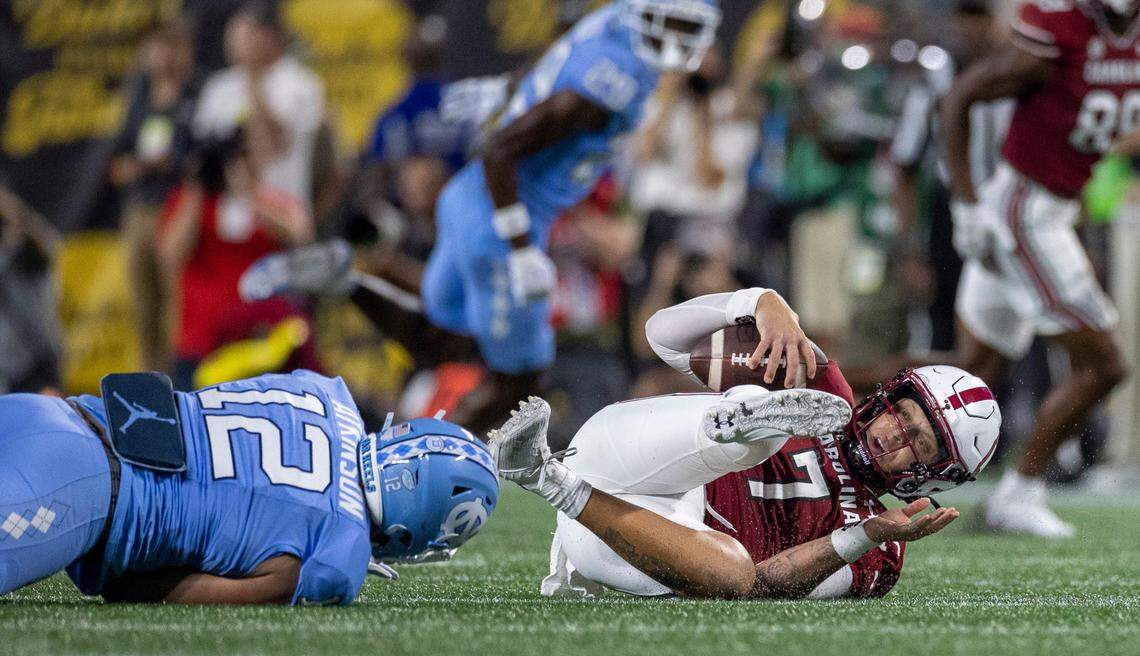 North Carolina’s Beau Atkinson (12) sacks South Carolina quarterback Spencer Rattler (7) for a six-yard loss in the third quarter on Saturday September 2, 2023 at Bank of America Stadium in Charlotte, N.C.