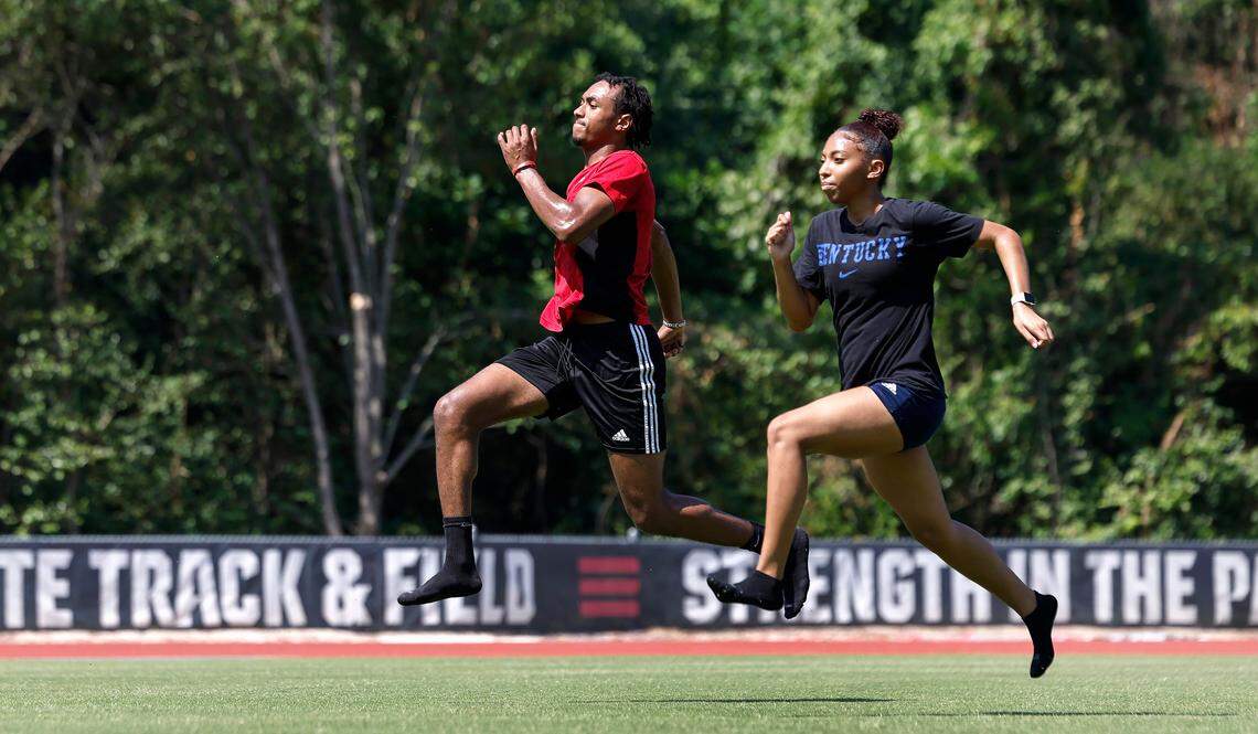 Trey Hill of Raleigh and Zee Simpson of Garner train at N.C. State’s Paul Derr Track and Field facility in Raleigh, N.C., Wednesday, June 26, 2024. The two didn’t let the heat stop them, taking frequent breaks to hydrate. Simpson said about training in the heat that when she thinks about skipping, she thinks about her future goals and that motivates her to not let the heat stop her.